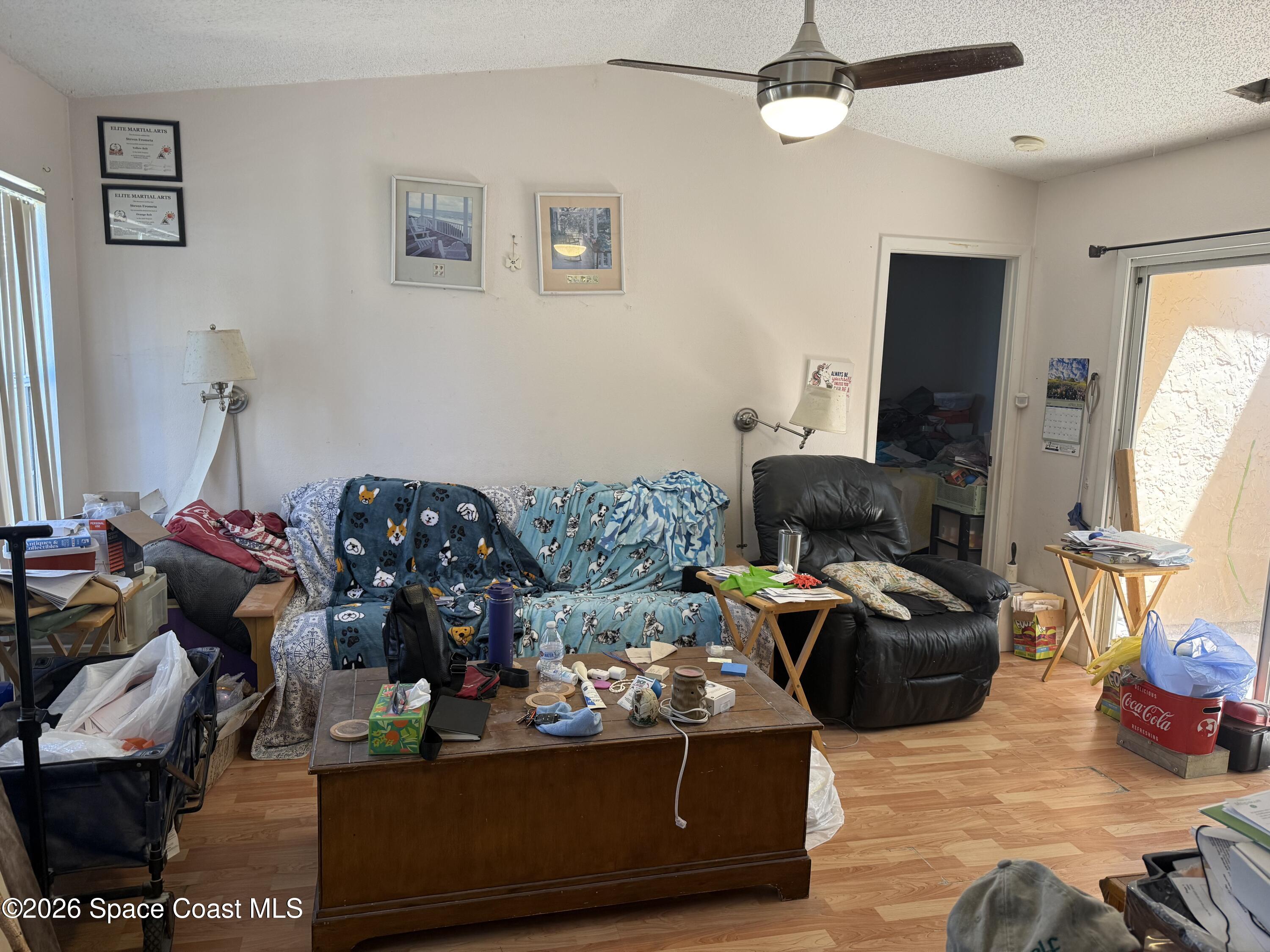 1490 Malibu Circle Northeast, Unit 112 Palm Bay, FL 32905 - Photo 3 of 6 a living room with furniture and a flat screen tv