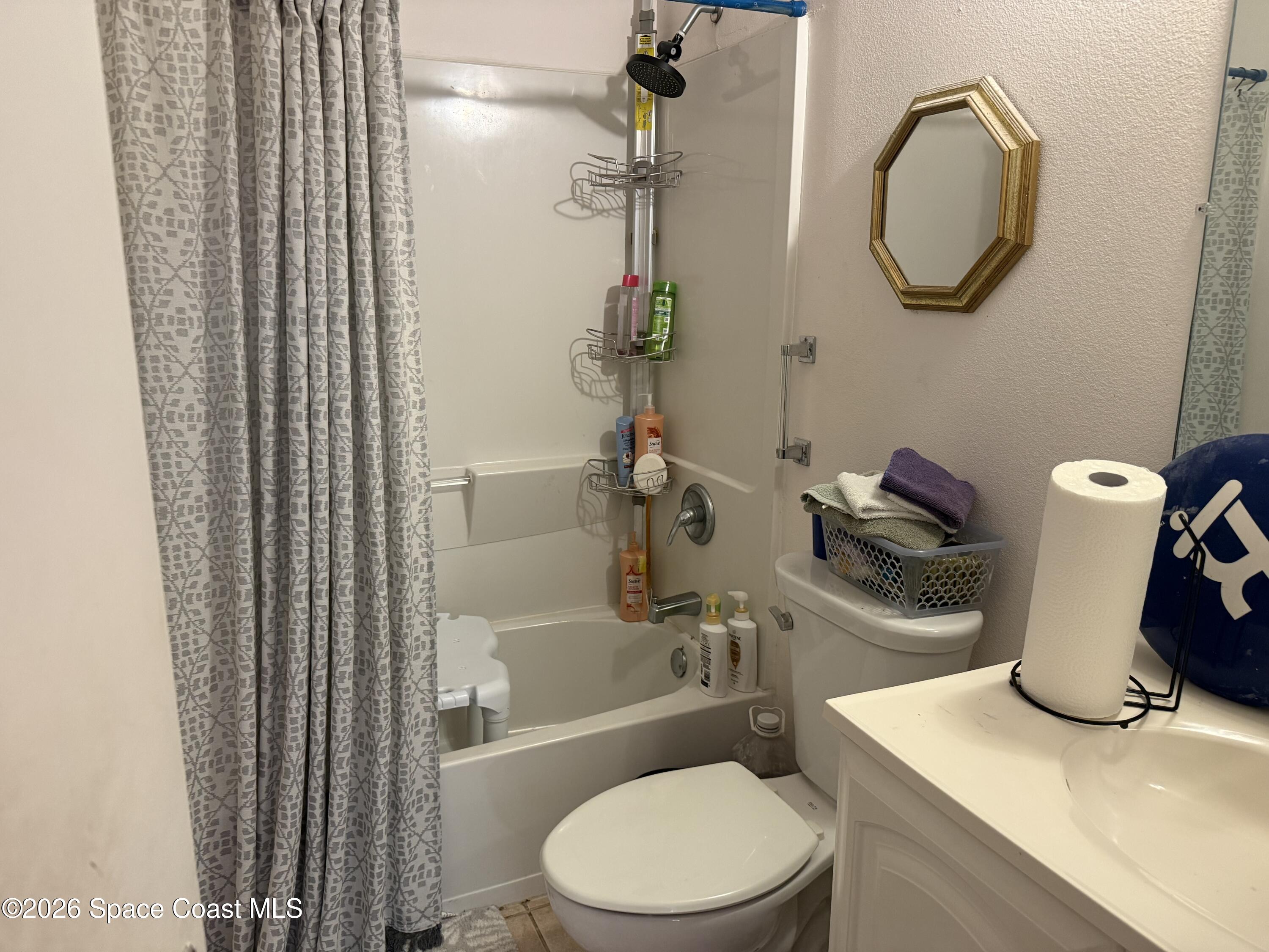 1490 Malibu Circle Northeast, Unit 112 Palm Bay, FL 32905 - Photo 5 of 6 a bathroom with a toilet and a sink