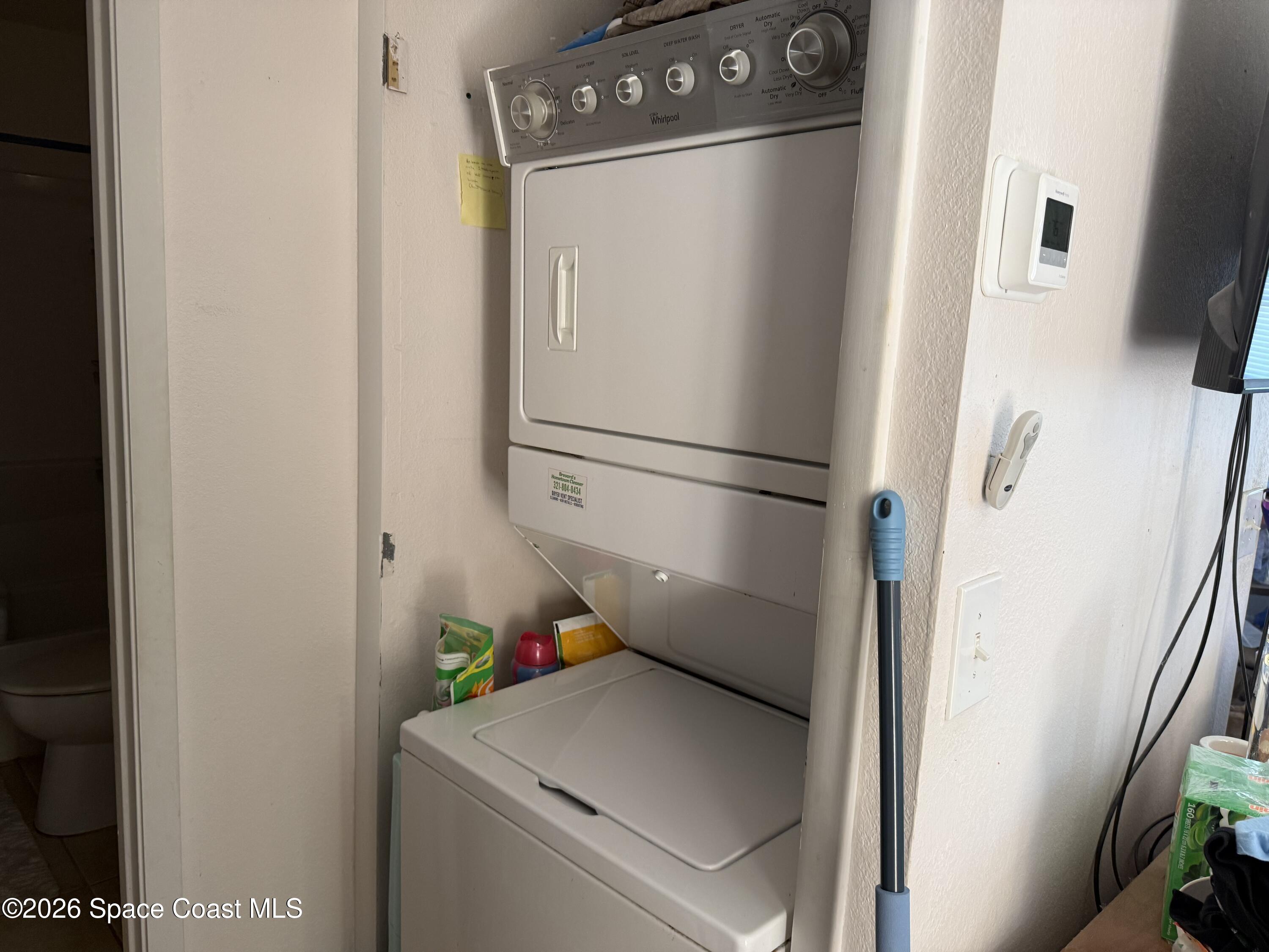 1490 Malibu Circle Northeast, Unit 112 Palm Bay, FL 32905 - Photo 6 of 6 a utility room with dryer and washer