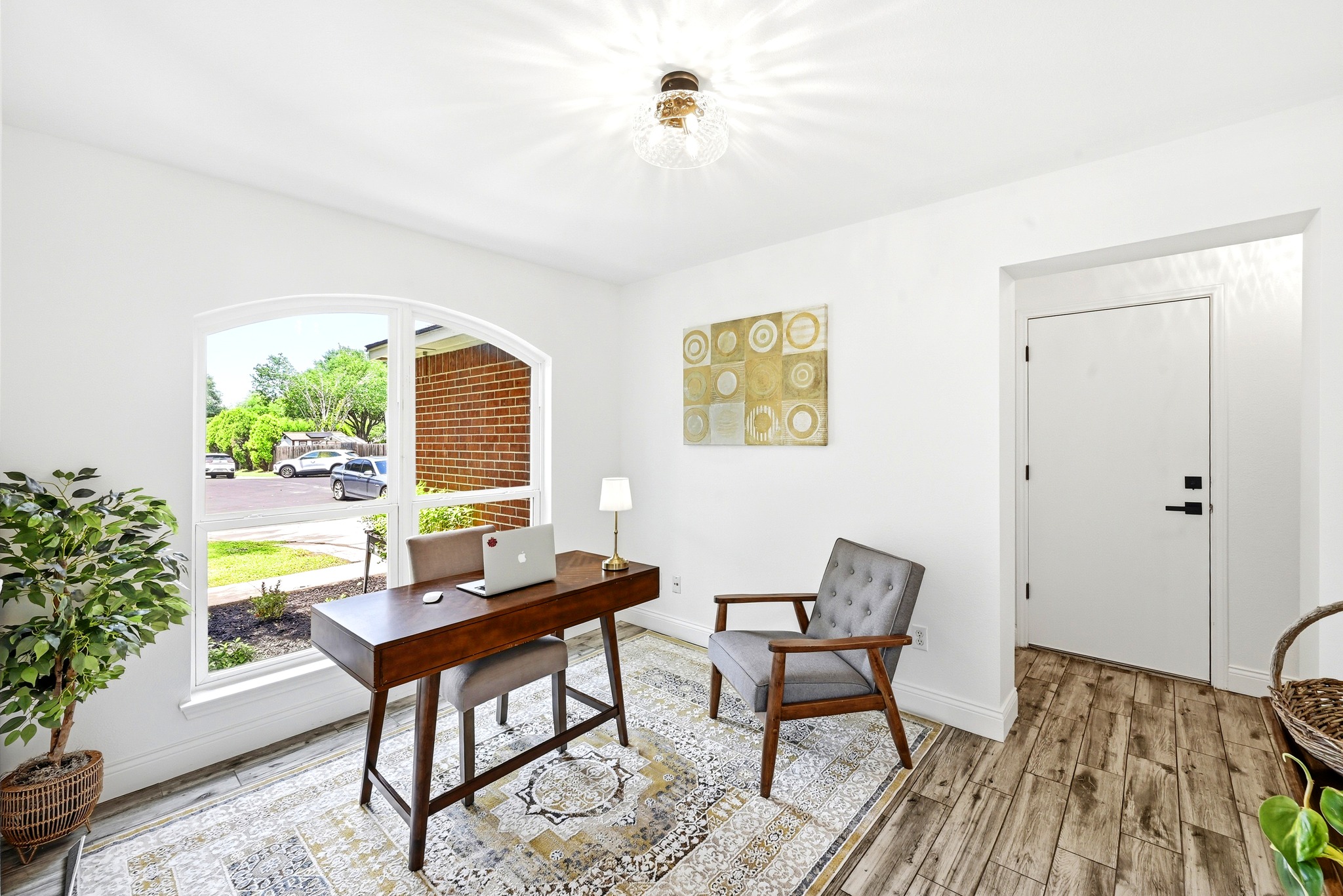 1801 Monks Tale Court Austin, TX 78748 - Photo 12 of 36 A well-lit study with a large arched window offering views of the neighborhood, perfect for focused work.