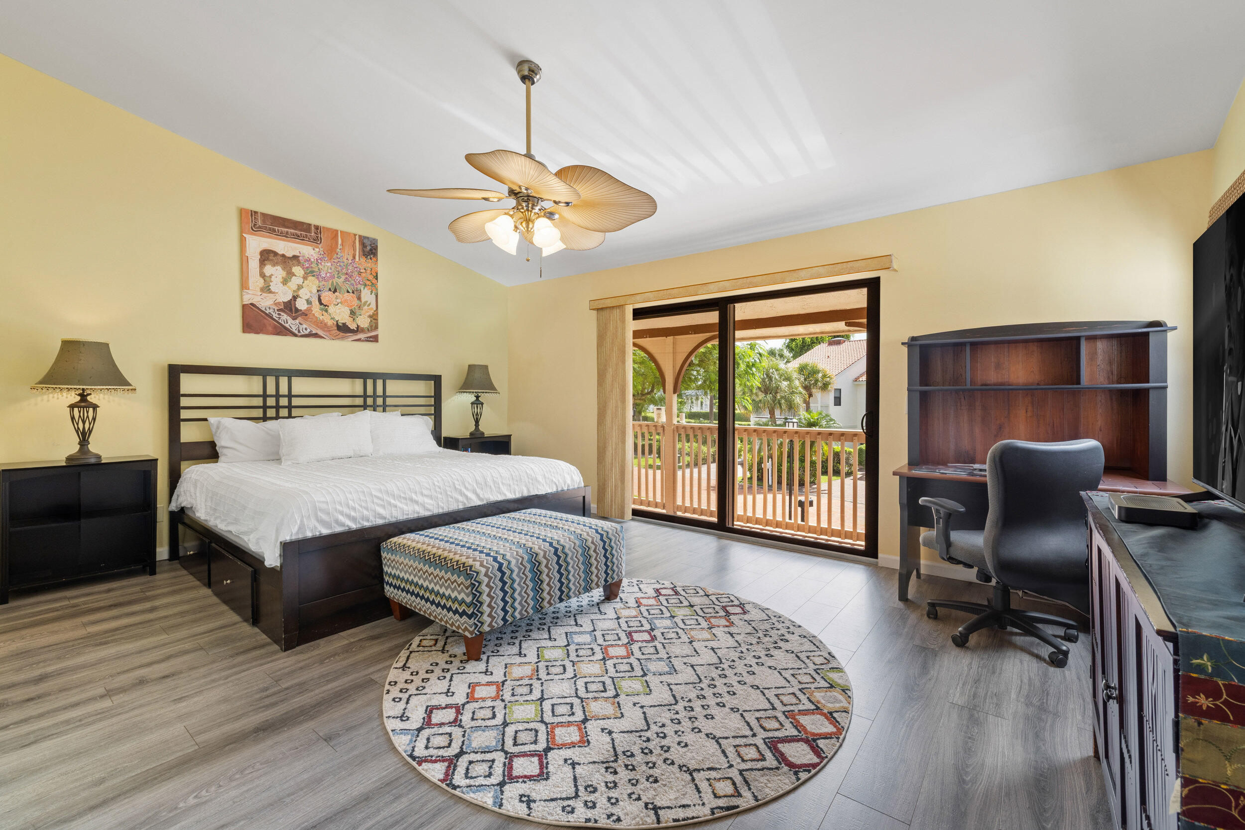 3501 Harbor Circle Delray Beach, FL 33483 - Photo 8 of 25 a bedroom with a large bed a chandelier and a window