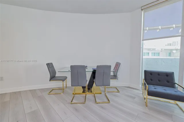 a view of a workspace with furniture and wooden floor