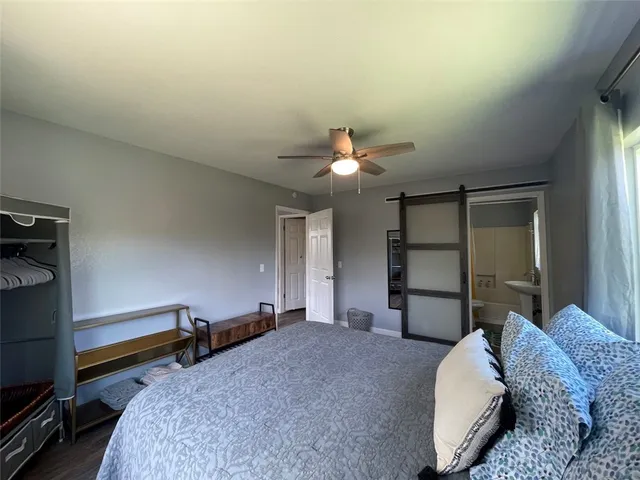 a bedroom with a bed wooden floor and window