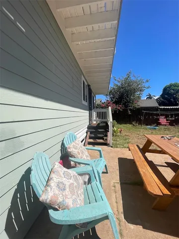 a view of a tennis ground with a table and chairs