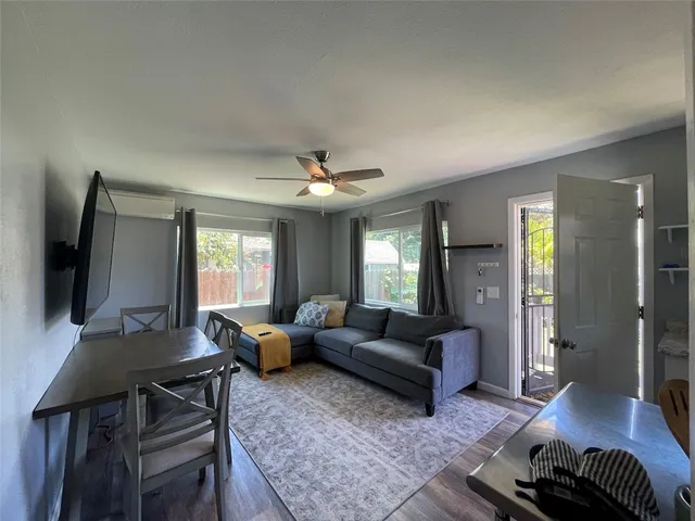 a living room with furniture and wooden floor