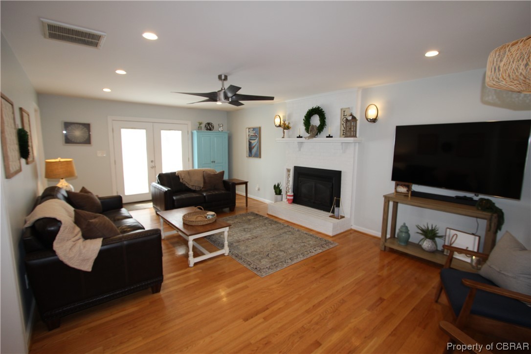 939 Long Road Mathews, VA 23109 - Photo 14 of 50 a living room with furniture a flat screen tv and a fireplace
