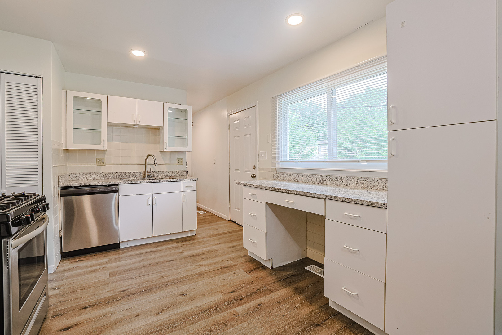 63 Sierra Road Montgomery, IL 60538 - Photo 12 of 22 a kitchen with a white stove top oven and sink