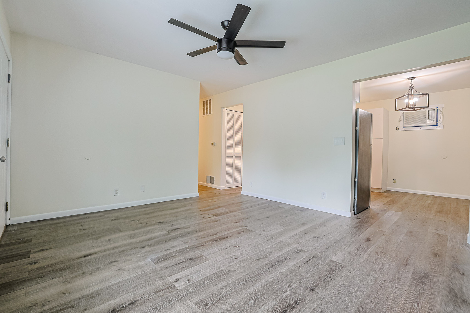 63 Sierra Road Montgomery, IL 60538 - Photo 4 of 22 a view of a room with wooden floor and a ceiling fan