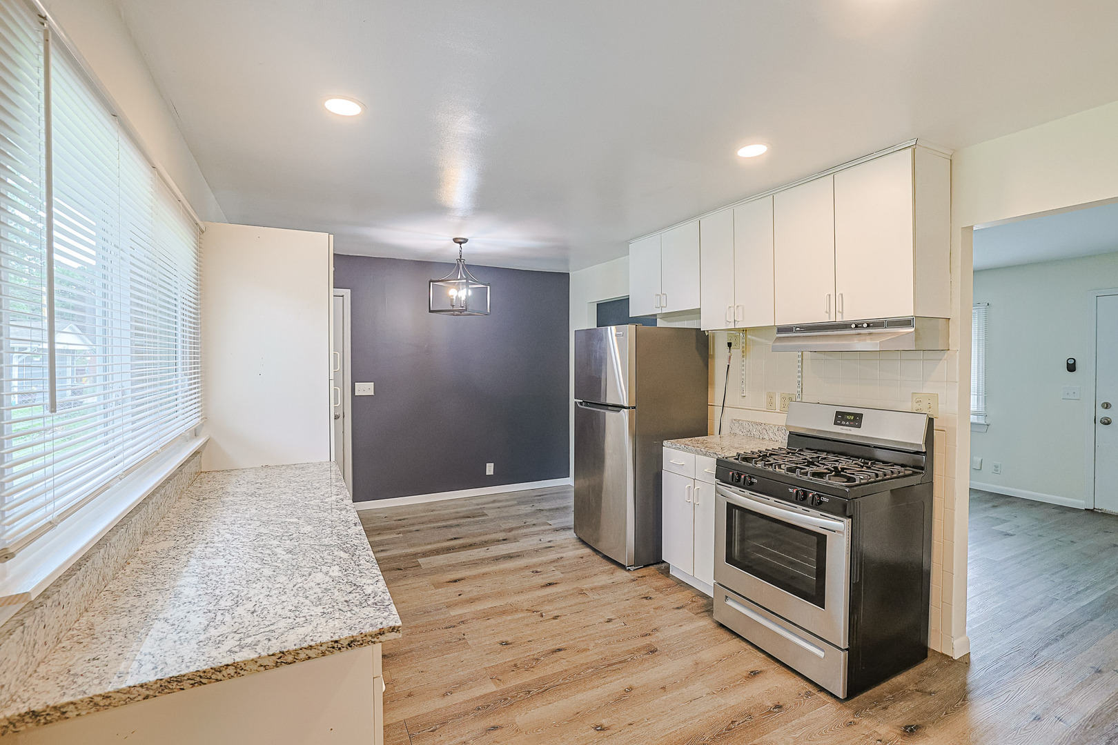 63 Sierra Road Montgomery, IL 60538 - Photo 8 of 22 a kitchen with stainless steel appliances granite countertop a stove a refrigerator and a sink