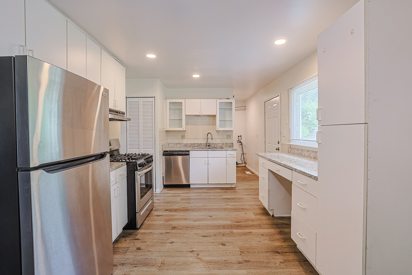 63 Sierra Road Montgomery, IL 60538 - Photo 9 of 22 a kitchen with white cabinets and white stainless steel appliances