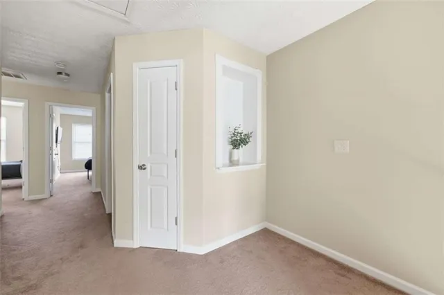 a spacious bedroom with a bed and a chair