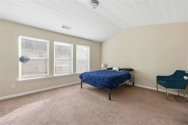 a room with a bed and a table in it