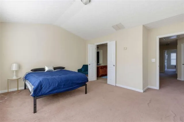 a bedroom with a bed and a television