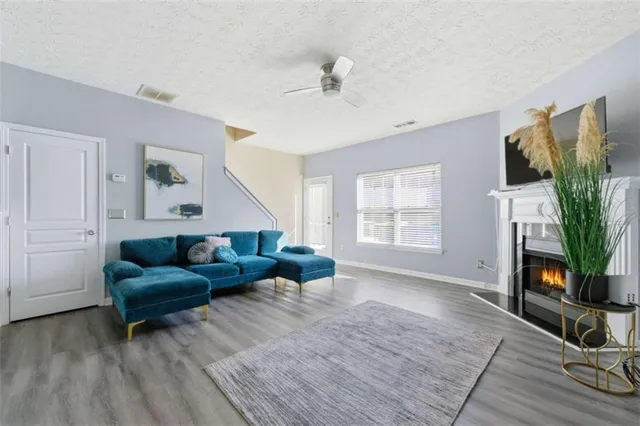 a living room with furniture and wooden floor