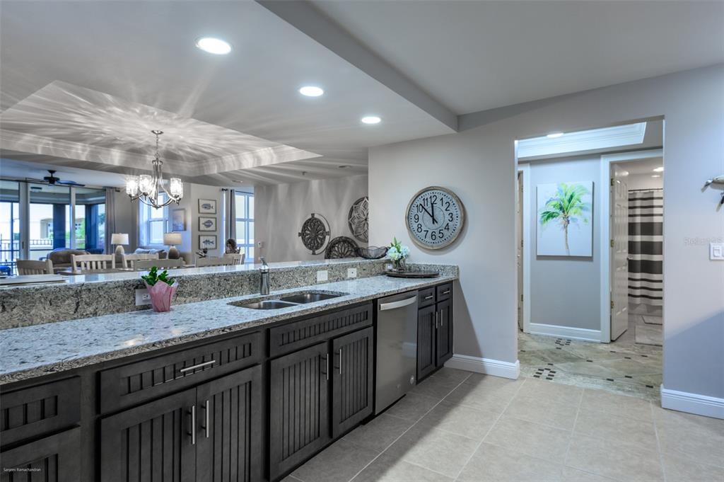 3313 Sunset Key Circle, Unit 107 Punta Gorda, FL 33955 - Photo 12 of 58 a kitchen with a sink a clock and cabinets