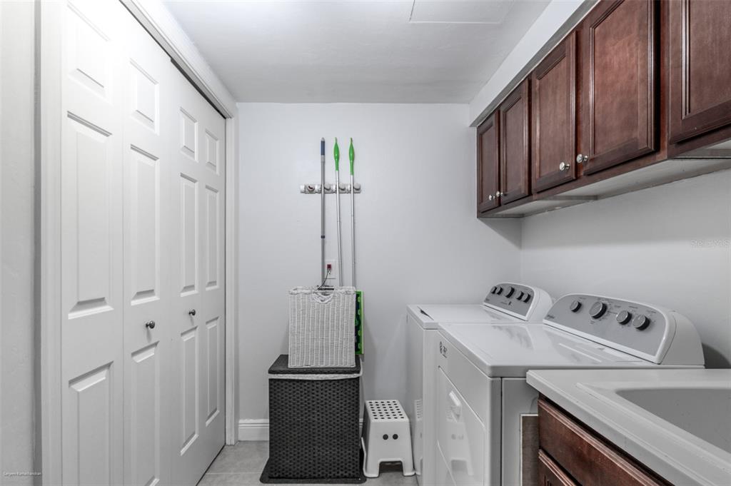 3313 Sunset Key Circle, Unit 107 Punta Gorda, FL 33955 - Photo 15 of 58 a view of cabinets with washer and dryer
