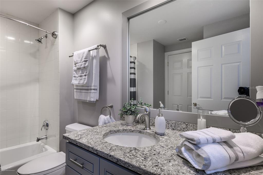 3313 Sunset Key Circle, Unit 107 Punta Gorda, FL 33955 - Photo 17 of 58 a bathroom with a granite countertop sink and a mirror