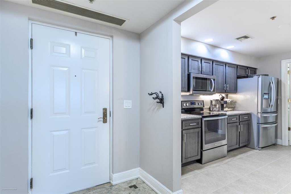 3313 Sunset Key Circle, Unit 107 Punta Gorda, FL 33955 - Photo 18 of 58 a kitchen with stainless steel appliances granite countertop a refrigerator and a sink