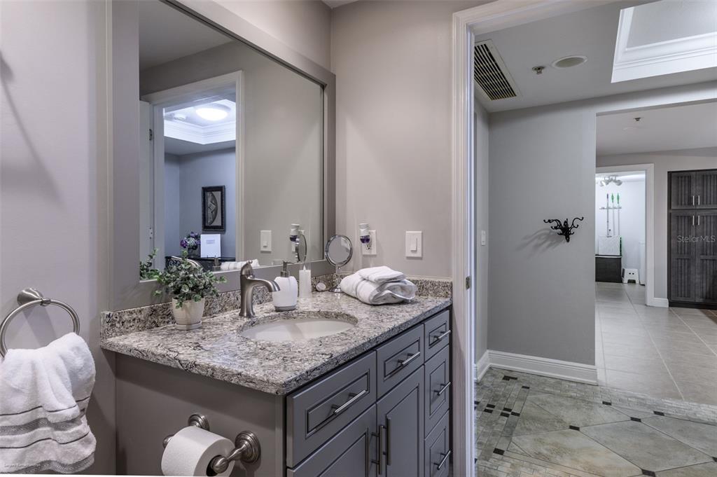 3313 Sunset Key Circle, Unit 107 Punta Gorda, FL 33955 - Photo 21 of 58 a bathroom with a granite countertop sink and a mirror