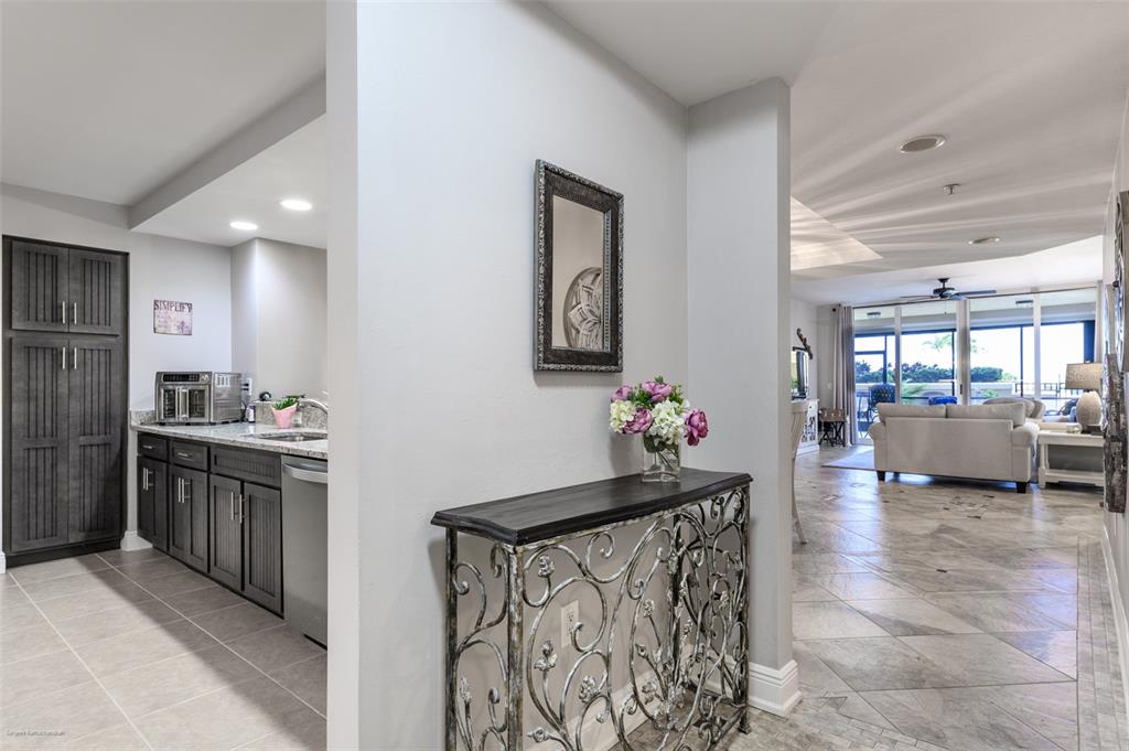 3313 Sunset Key Circle, Unit 107 Punta Gorda, FL 33955 - Photo 23 of 58 a kitchen with granite countertop a sink cabinets and stainless steel appliances
