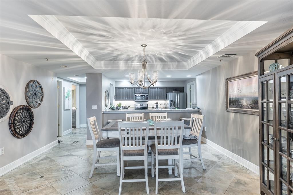 3313 Sunset Key Circle, Unit 107 Punta Gorda, FL 33955 - Photo 27 of 58 a view of a dining room with furniture a chandelier and wooden floor