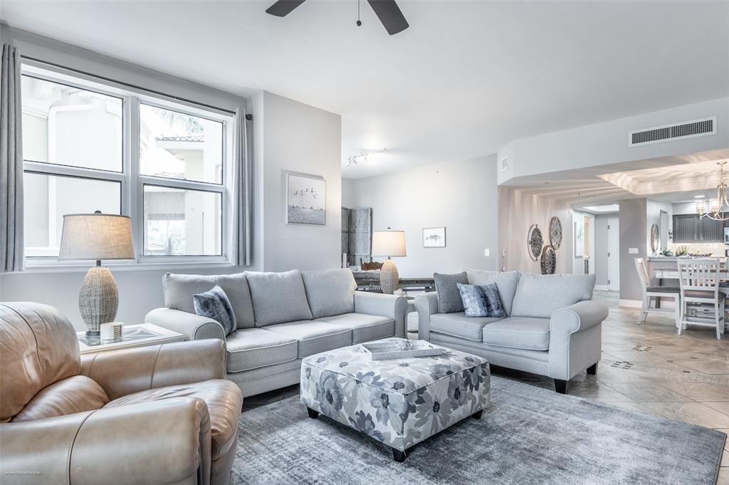 3313 Sunset Key Circle, Unit 107 Punta Gorda, FL 33955 - Photo 33 of 58 a living room with furniture and a large window