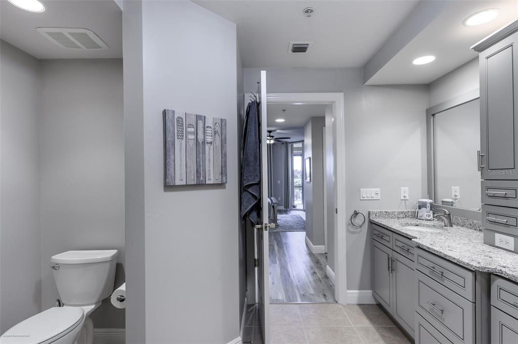 3313 Sunset Key Circle, Unit 107 Punta Gorda, FL 33955 - Photo 40 of 58 a spacious bathroom with a granite countertop sink mirror vanity and toilet