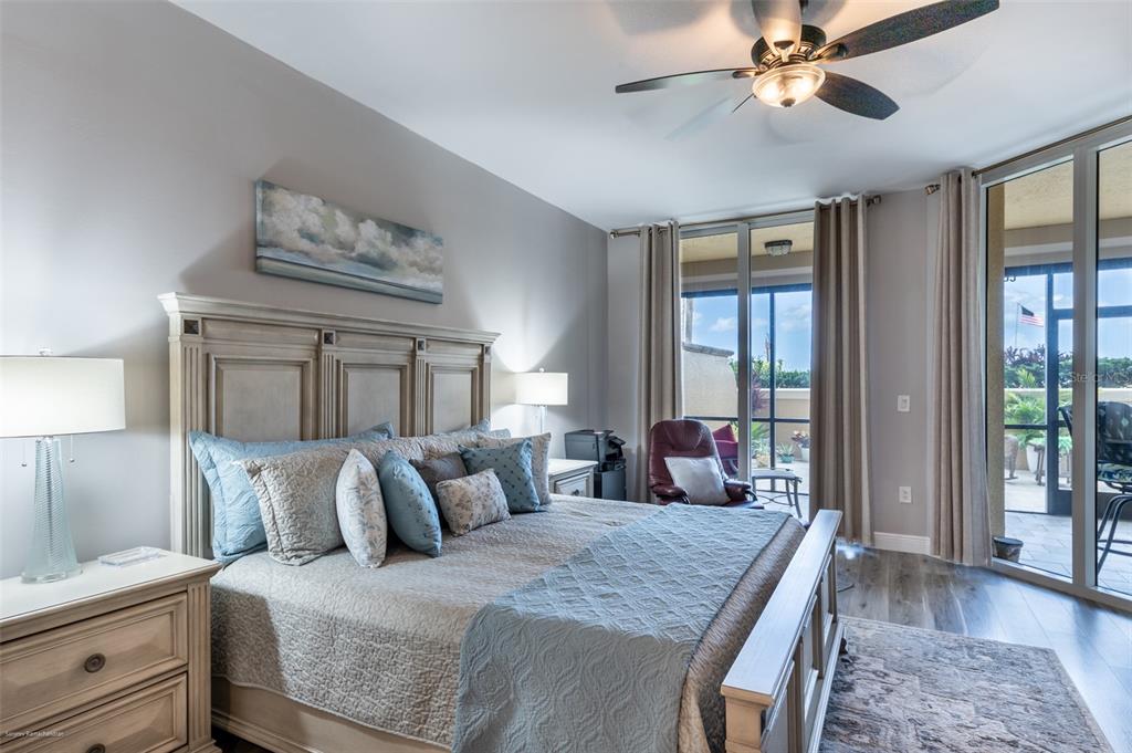 3313 Sunset Key Circle, Unit 107 Punta Gorda, FL 33955 - Photo 6 of 58 a bedroom with a large bed and a chandelier