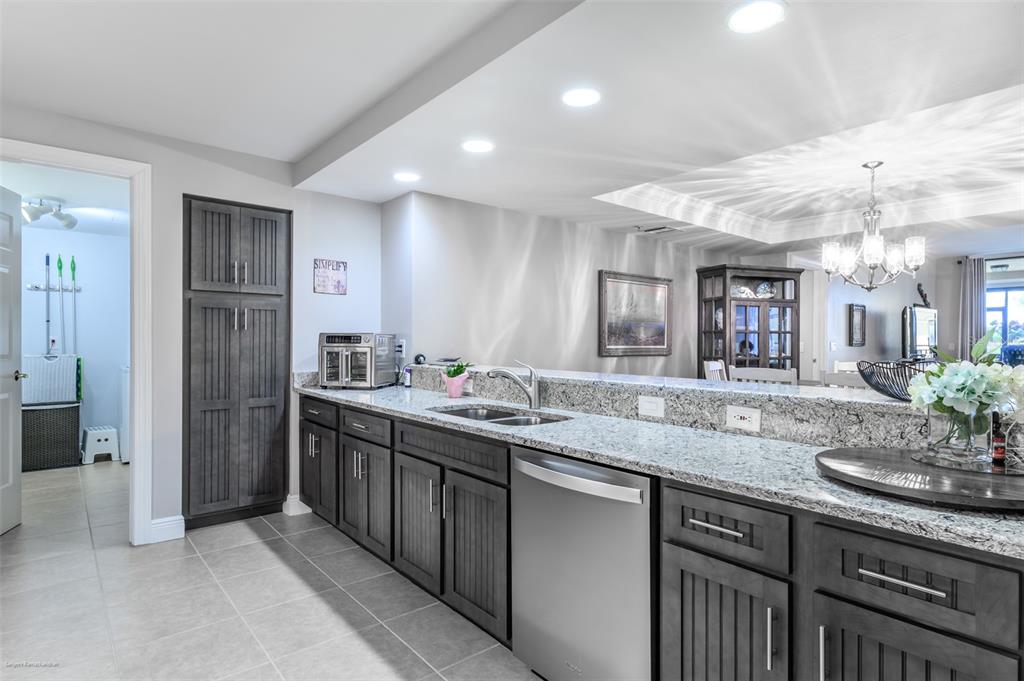 3313 Sunset Key Circle, Unit 107 Punta Gorda, FL 33955 - Photo 8 of 58 a bathroom with a granite countertop sink and a mirror