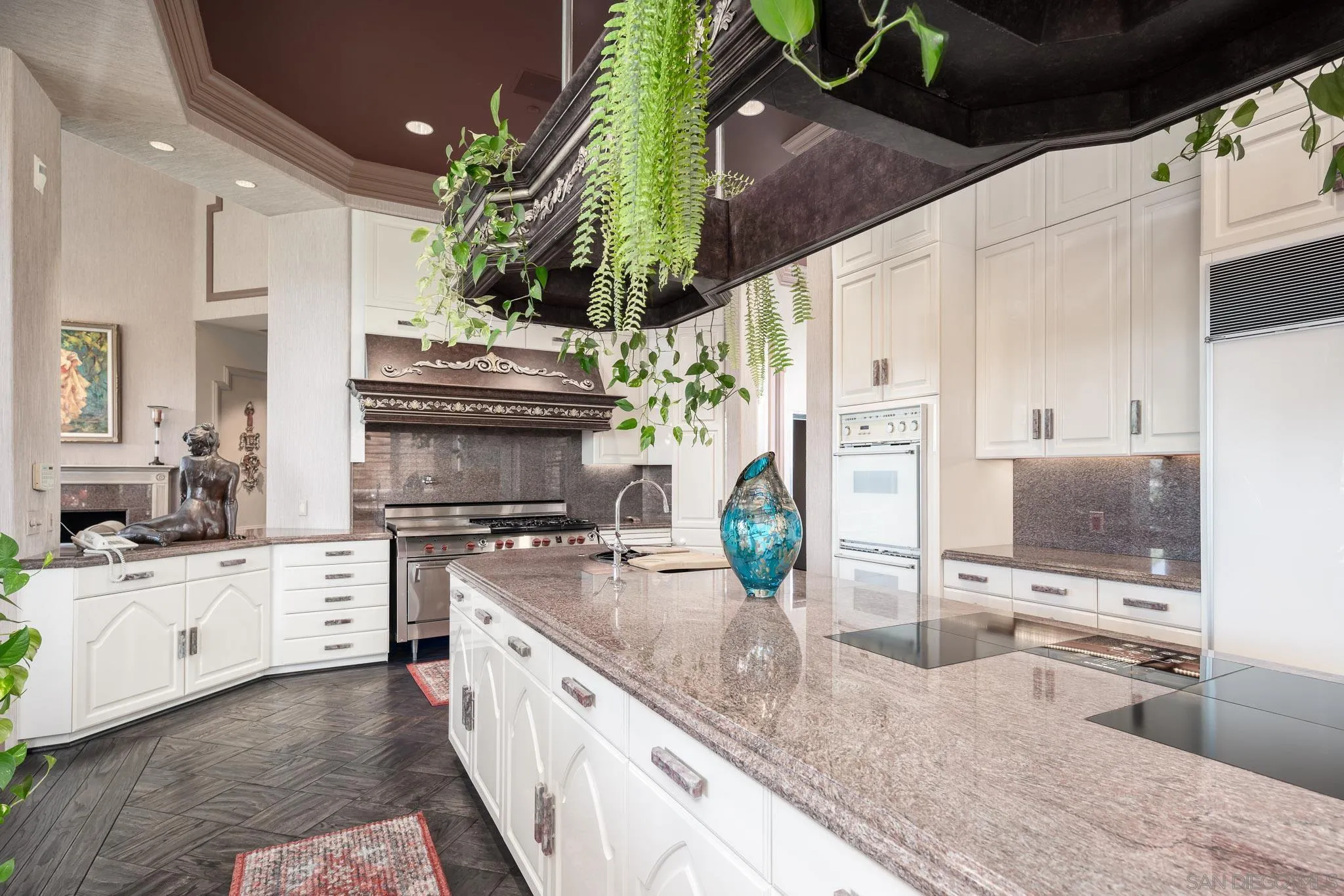 5893 Winland Hills Drive Rancho Santa Fe, CA 92067 - Photo 16 of 41 a kitchen with stainless steel appliances kitchen island granite countertop a sink a stove and a wooden floors