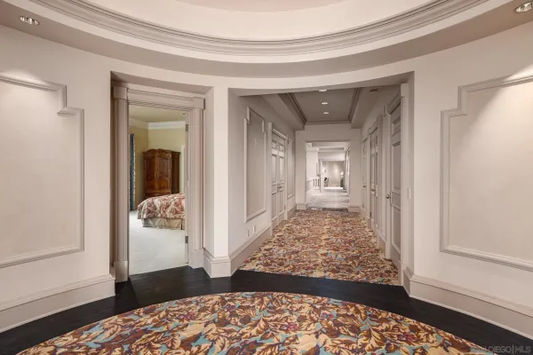 a bedroom with furniture and large windows