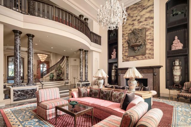 a living room with furniture a large window and a fireplace