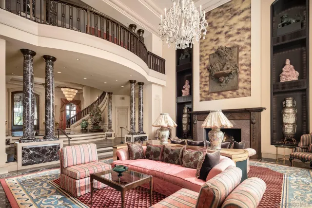 a living room with furniture a large window and a fireplace