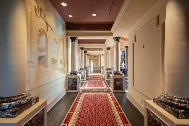 a backyard of a house with sofas table and chairs