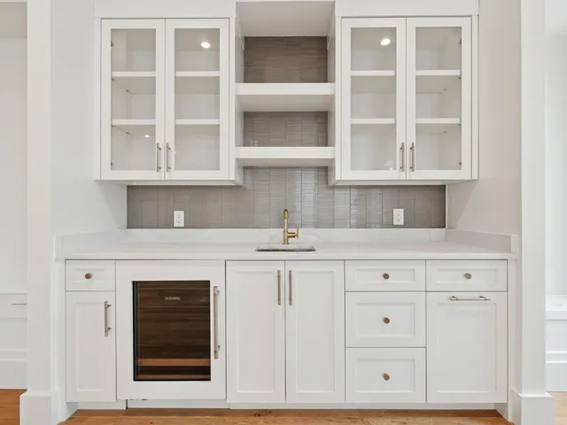 a kitchen with white cabinets and a sink