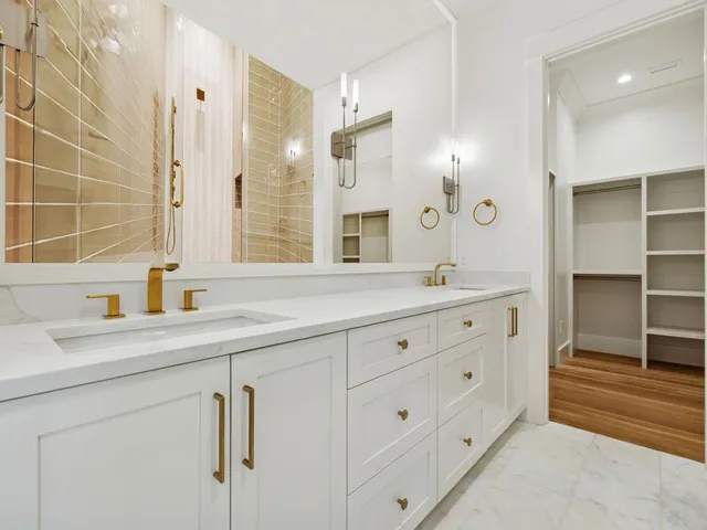 a bathroom with double sink and a mirror