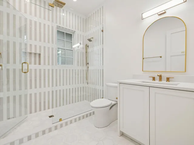 a bathroom with a sink toilet and shower