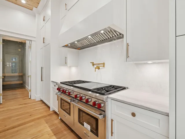 a kitchen with stove and cabinets