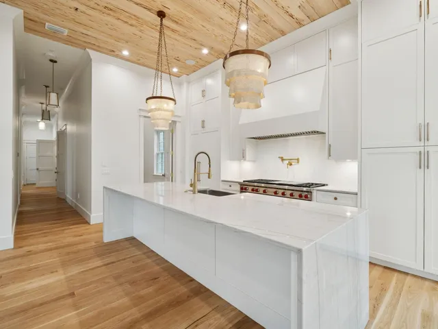 a kitchen with stainless steel appliances a stove a sink and a refrigerator