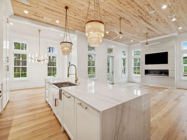 a large kitchen with kitchen island granite countertop a large island in the center and stainless steel appliances