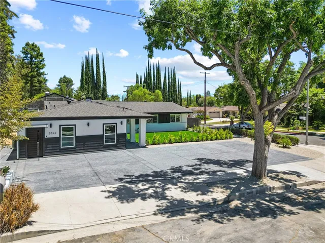 a view of a house with a tree in the background