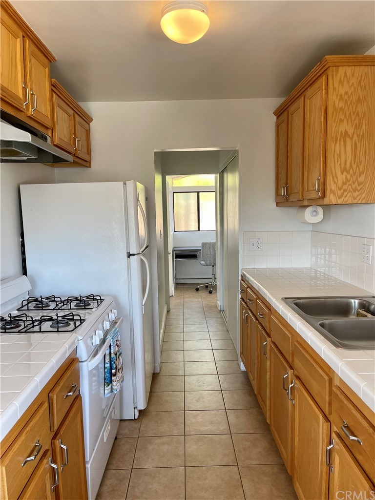 416 Aster Street Laguna Beach, CA 92651 - Photo 4 of 14 a kitchen with stainless steel appliances granite countertop a sink stove and refrigerator