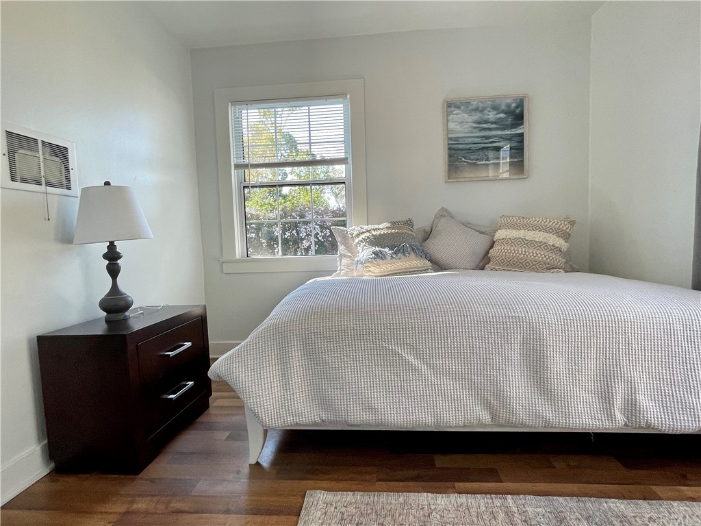 416 Aster Street Laguna Beach, CA 92651 - Photo 7 of 14 a bedroom with a bed and wooden floor