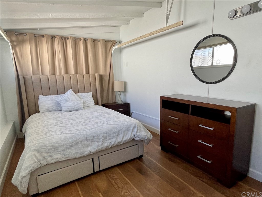 416 Aster Street Laguna Beach, CA 92651 - Photo 8 of 14 a bedroom with a large bed and a mirror on the dresser