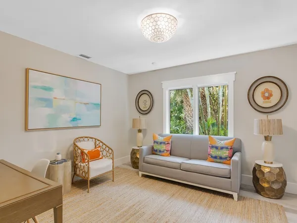 a living room with furniture and a large window