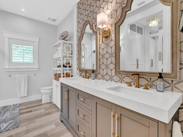 a bathroom with a sink double vanity granite and a mirror