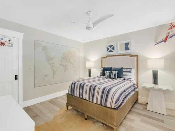 a bedroom with a bed and a painting on the wall