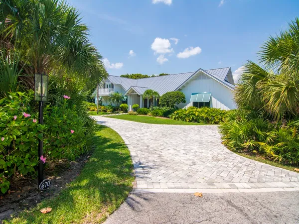a view of a house with a yard and garden