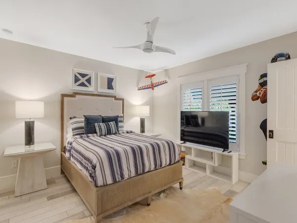 a bedroom with a bed and a television