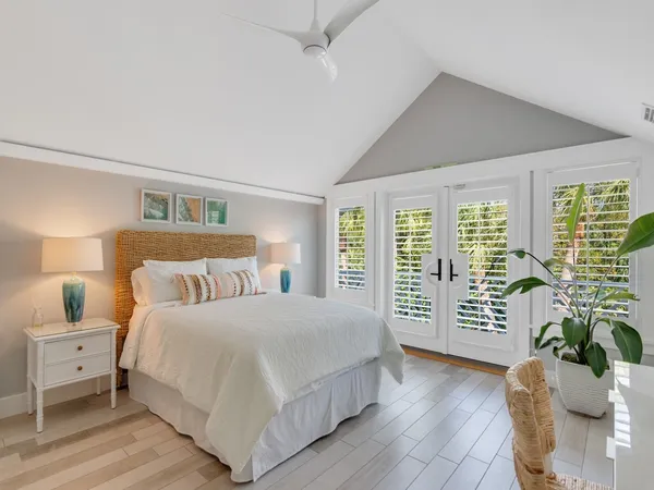 a bedroom with a large bed and a window